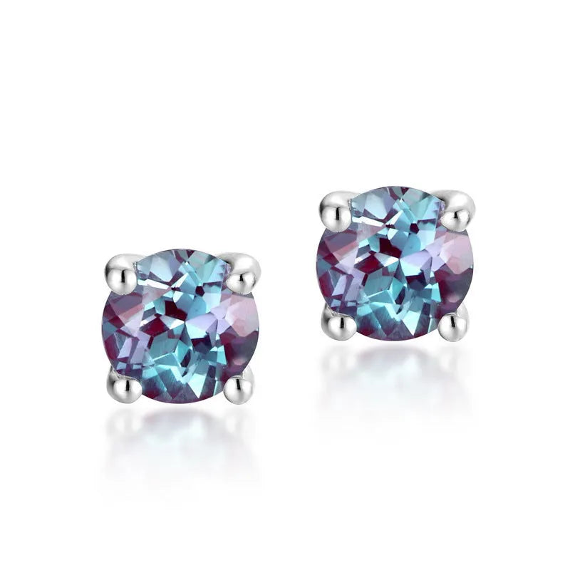 A pair of round, geometric 925 silver ear studs featuring a cultivated Alexandrite Alexander Stone.