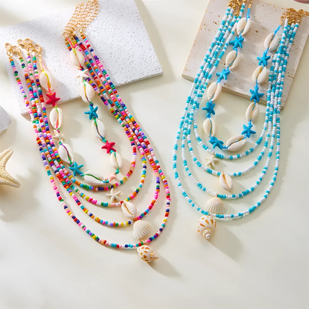 Five-piece women's necklace set with starfish, shell and conch bead pendants on adjustable chains