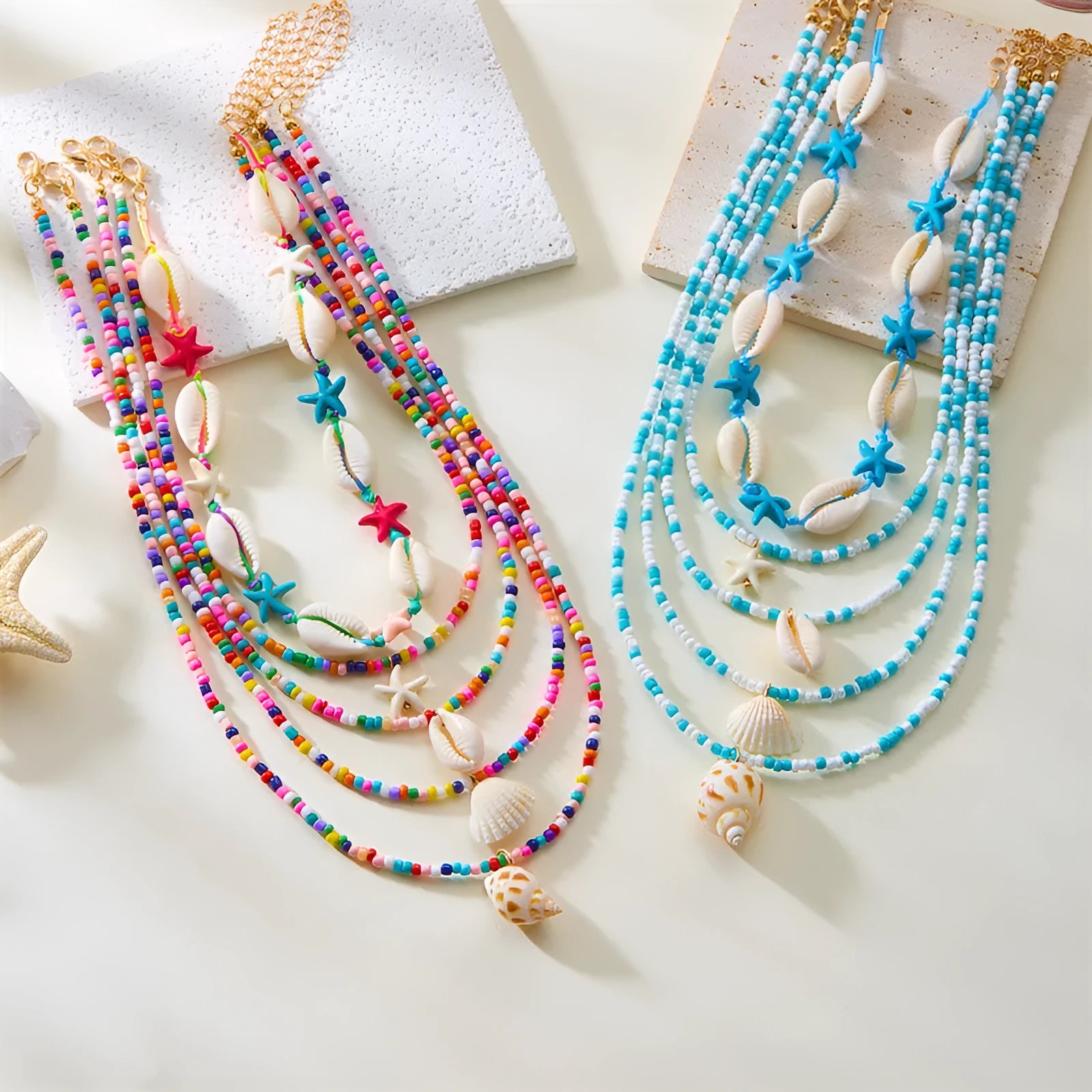 Five-piece women's necklace set with starfish, shell and conch bead pendants on adjustable chains