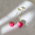 Pair of acrylic peach-shaped earrings on a white background, showing small and large size options.