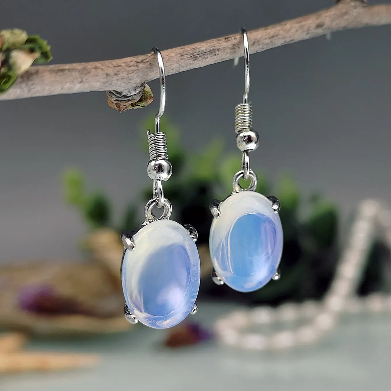 Moonlight white opal earrings with a retro cross pendant in a drop shape