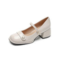 Women's apricot patent leather heel pumps with a chunky block heel and buckle fastening