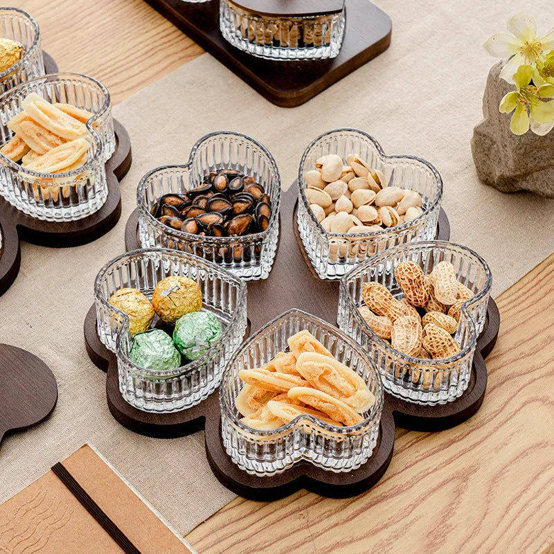Glass fruit platter with transparent heart-shaped lids covering compartmentalised snack trays in retro design