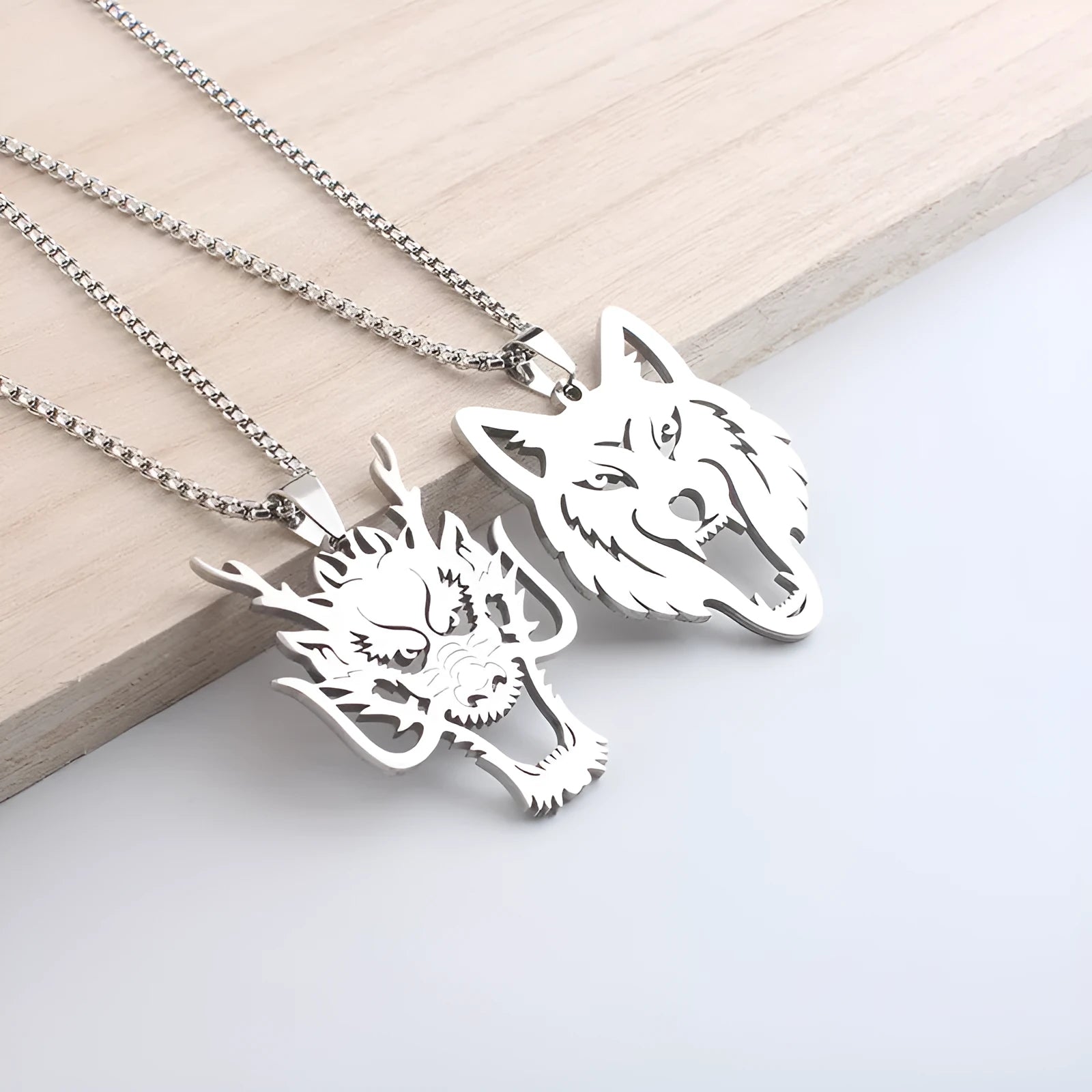 Hollow wolf head stainless steel pendant necklace with polished finish and 60cm chain on neutral background