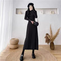 Women's high-waist knitted A-line skirt dress in a solid colour, mid-length below the knees.