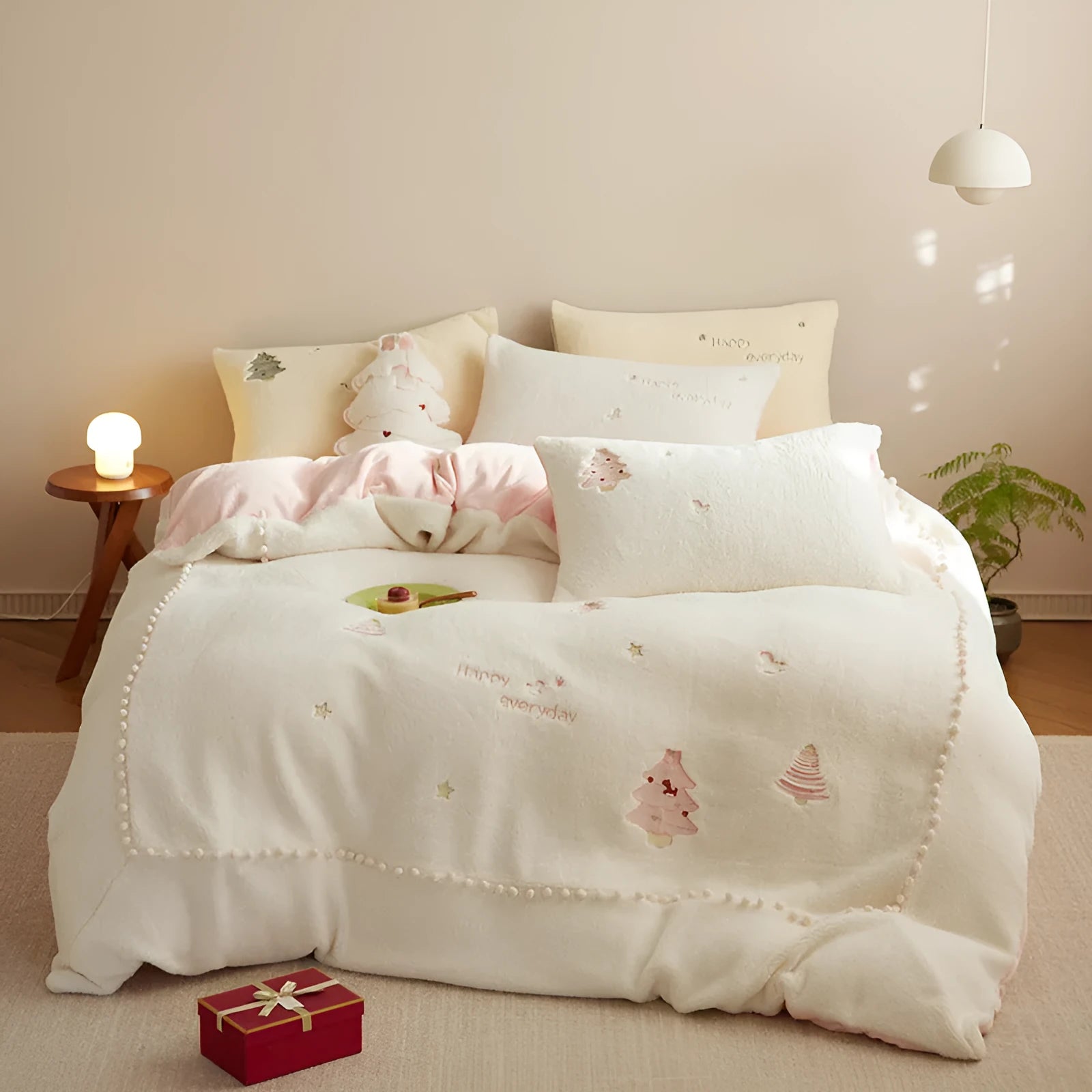 Princess-style four-piece bedding set with green Christmas tree pattern on a bed.