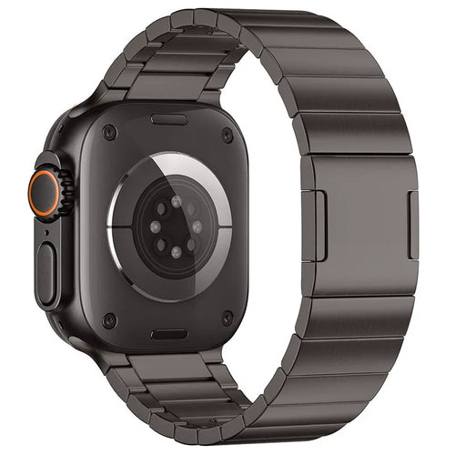 Stainless steel Apple Watch strap with magnetic buckle in multiple colour options on a wrist.