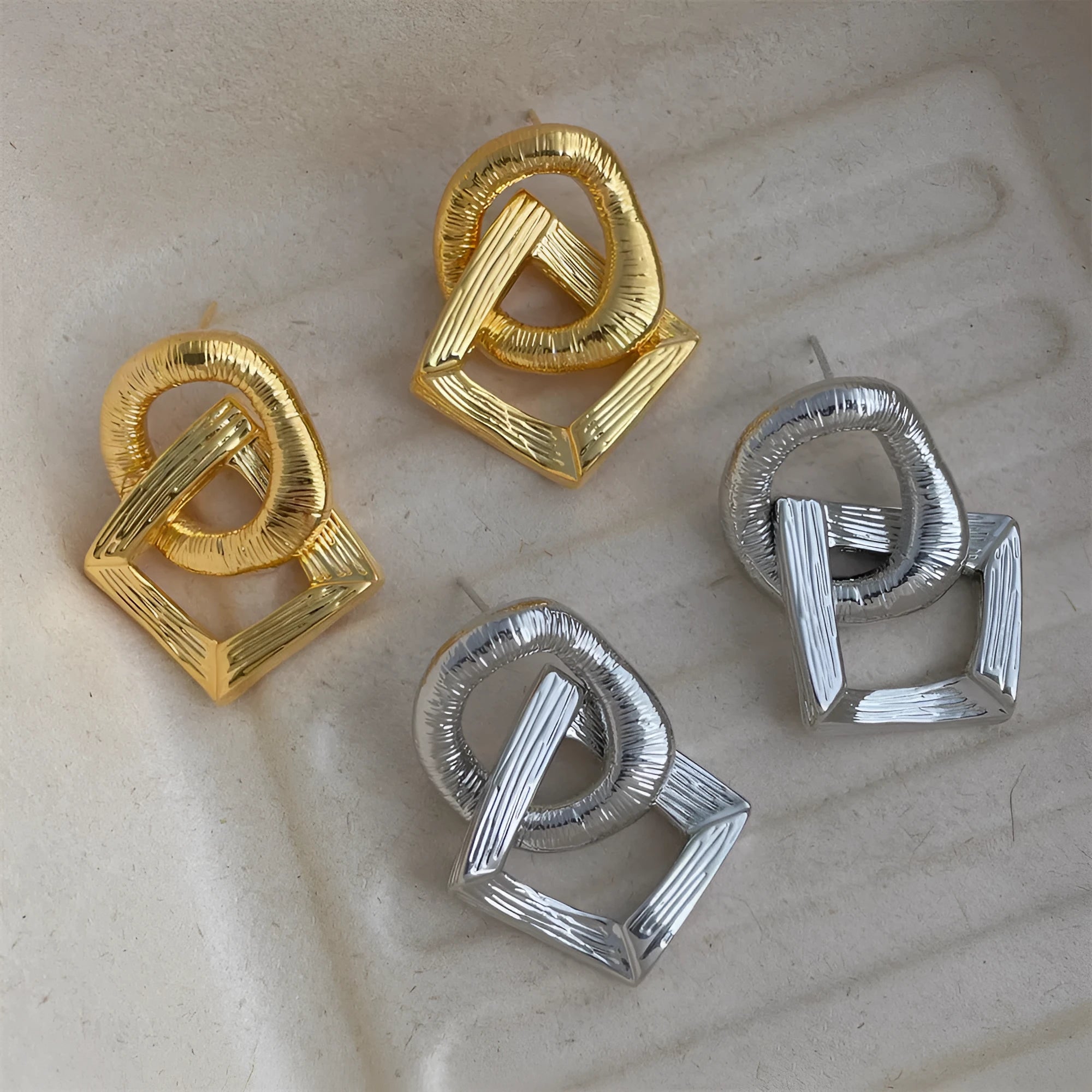 Geometric circle pendant drop earrings in gold or silver tone with a 3.4cm length.