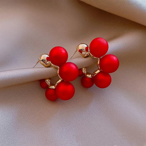 Round alloy bell drop earrings in red colour for pierced ears