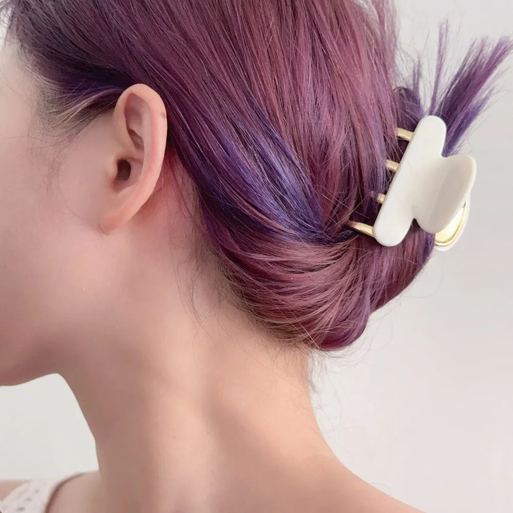 Medium metal grip acetate hair barrettes in four colours: fairy white, leopard print, creamy-white, and ink colour