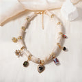 Gold-plated chain necklace with a white heart-shaped resin bamboo pendant.