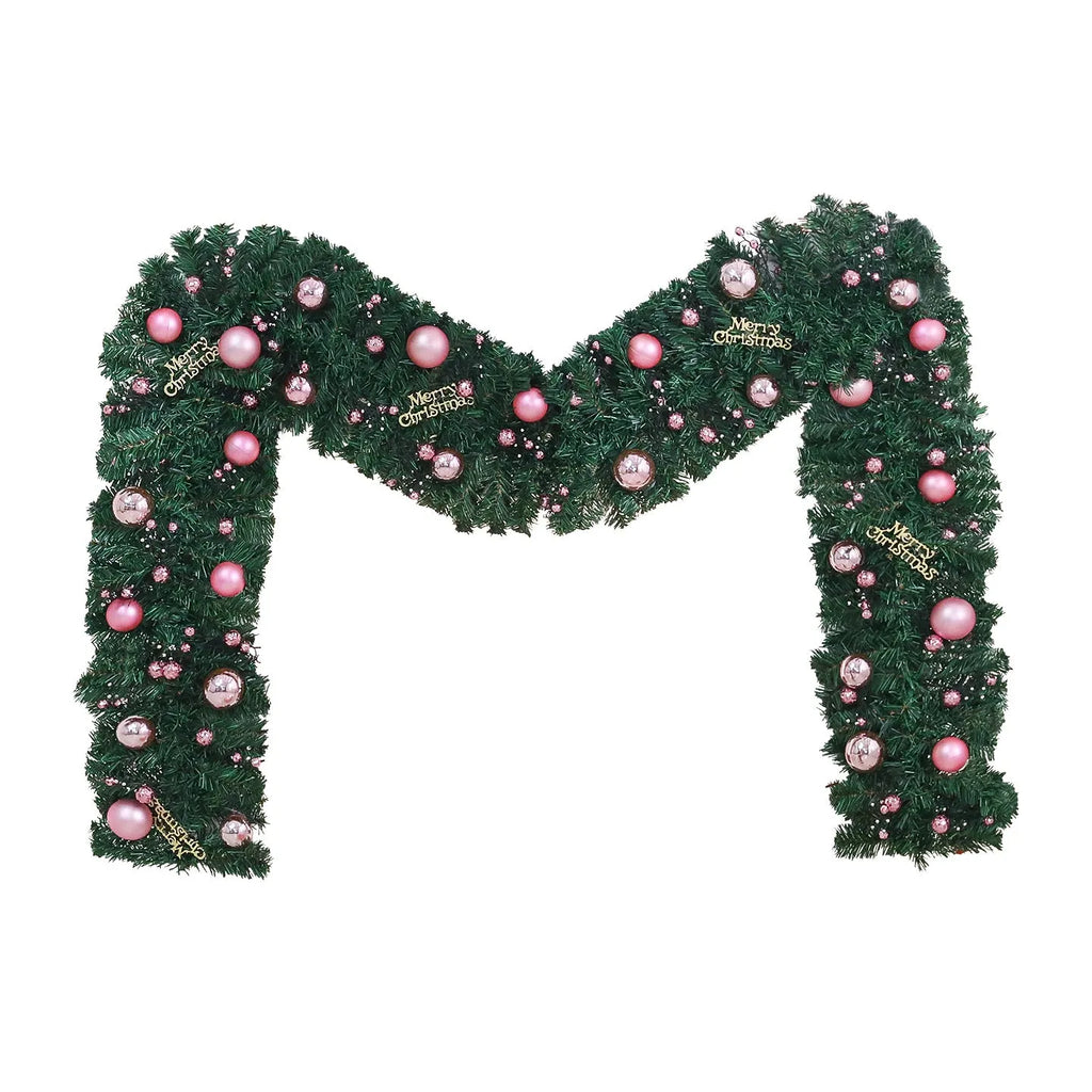 Pink Christmas rattan garland with small fruit details and LED lights draped across doorway