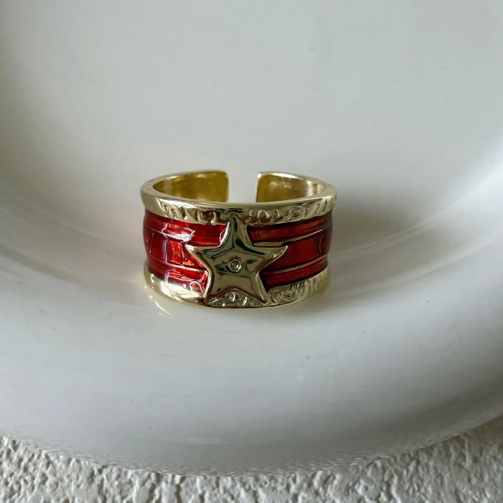 Adjustable geometric drop oil copper ring with a distressed finish in multiple colours.