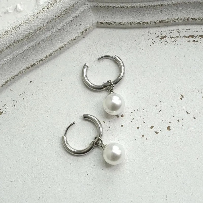 Geometric alloy drop earrings for women with round titanium steel pearl accents.