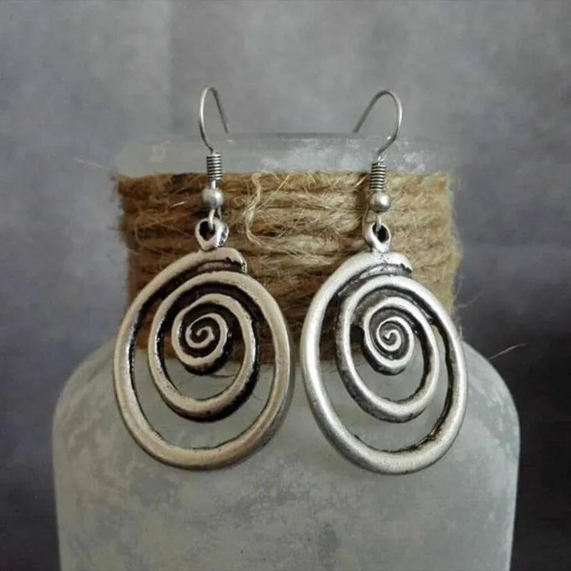 Silver geometric spiral distressed alloy dangle earrings showing retro design.