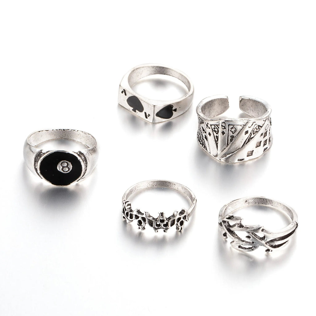 Black alloy poker ring with a detailed retro spade design on a female model's hand.