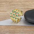 Gold plated copper ring with three green zircon stones in layered arrangement on wide band