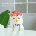 Ceramic hanging foot flowerpot with cartoon design for succulent plants on desktop
