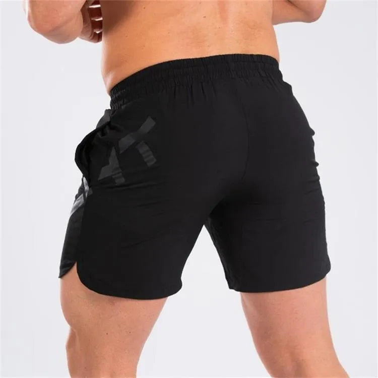 Men's black elastic waist knee-length quick-dry training shorts on a white background.