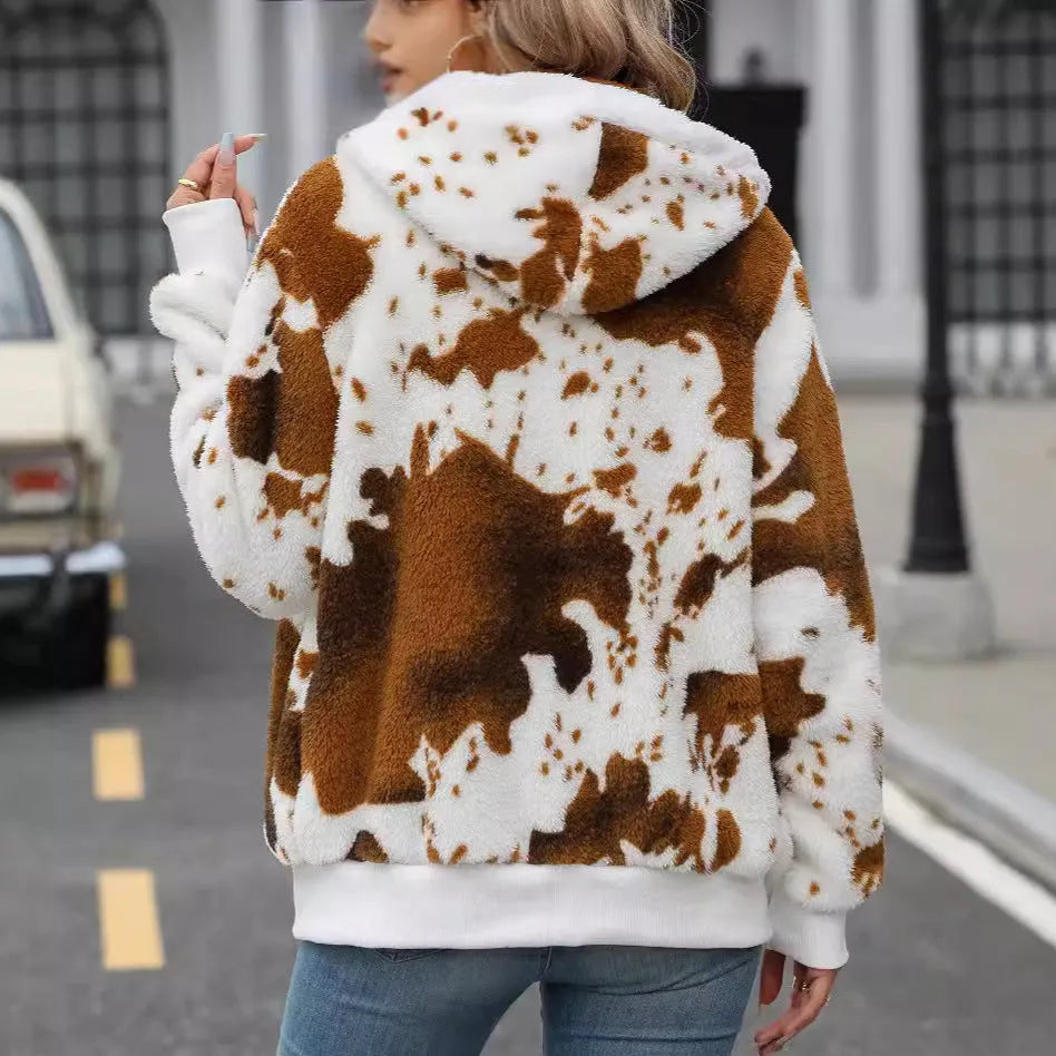 Yellow and brown cow print hooded cardigan jacket with a full front zip on a model.