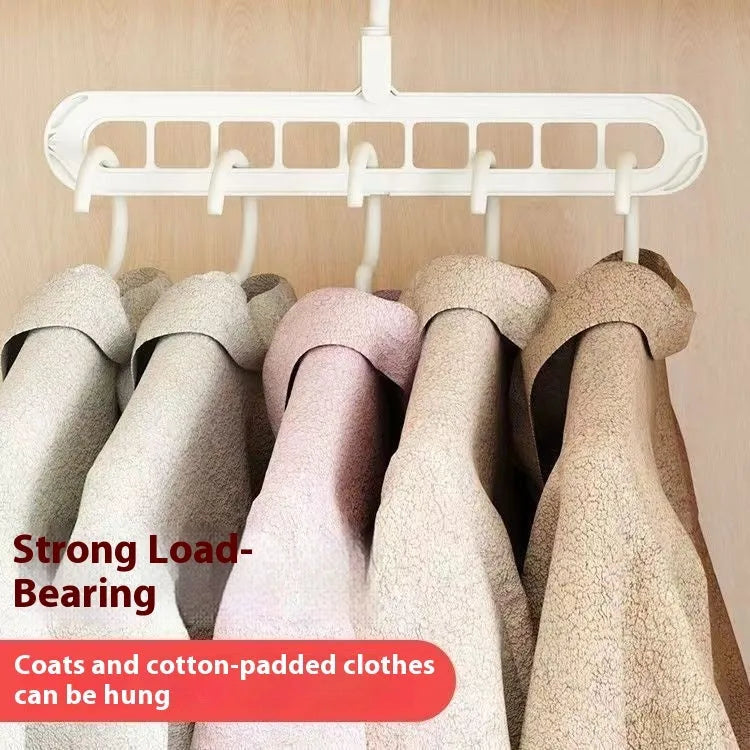 Green plastic nine-hole folding hanger for trousers shown in a dormitory wardrobe.