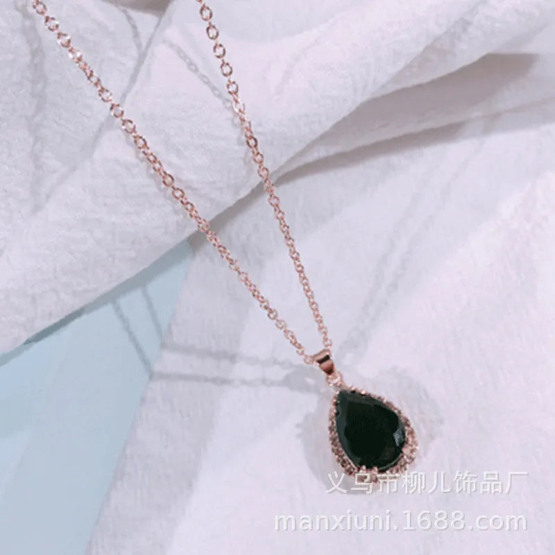 Rose gold water drop shape necklace with rhinestone geometric detailing in pink colour