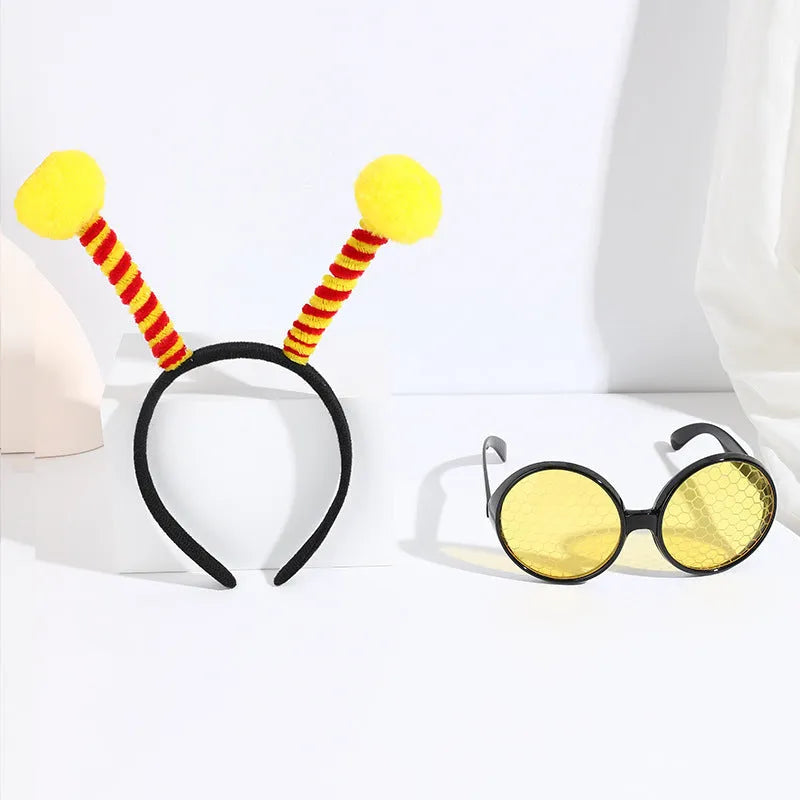 Yellow children's costume headband and glasses set with bee, butterfly, and ladybug patterns.