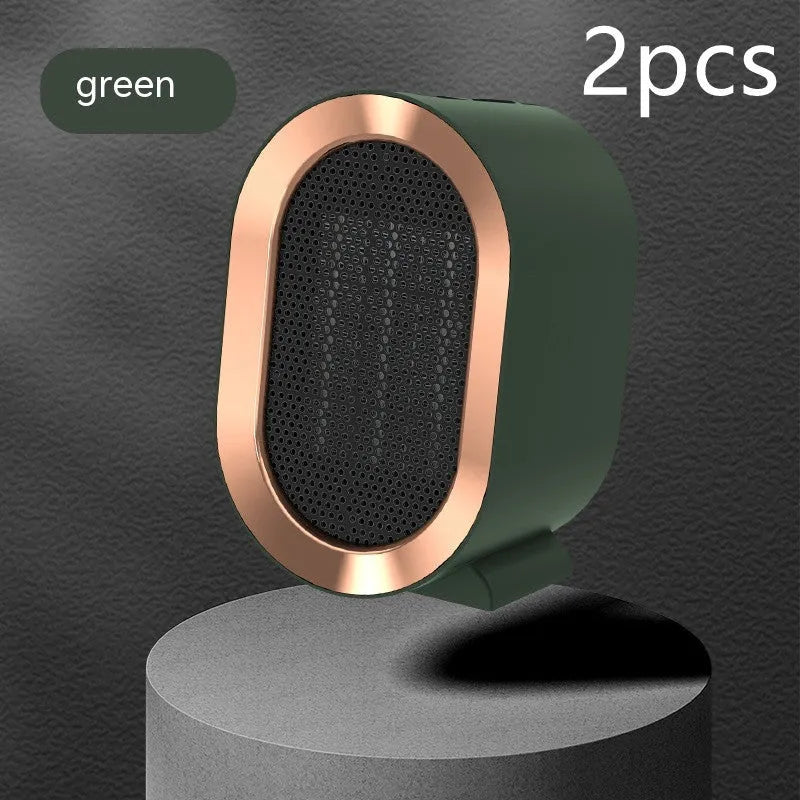 Compact black desktop electric fan heater with mechanical control dials and a safety grille.