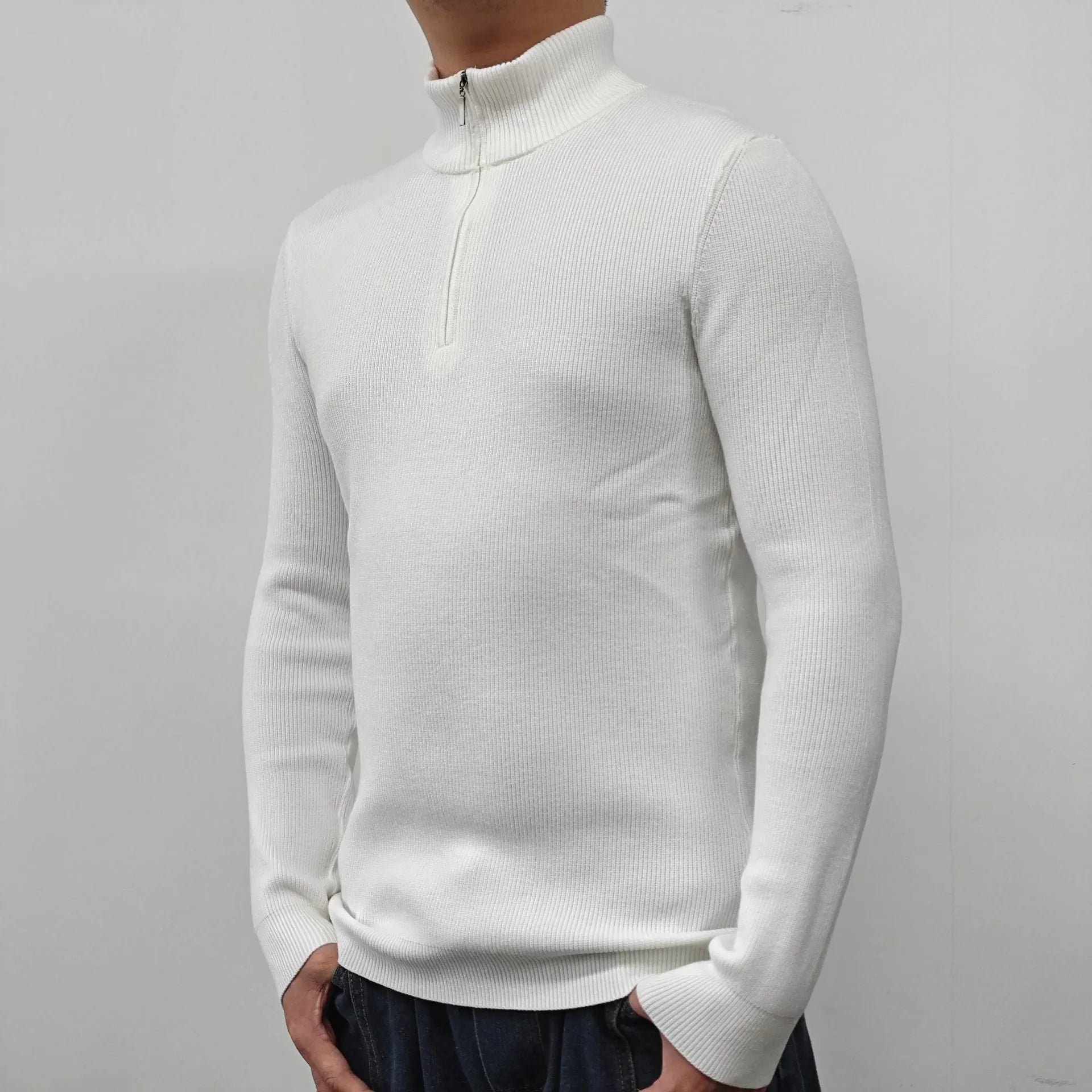 Man wearing a gray zip-front half-turtleneck long sleeve cotton blend sweater.