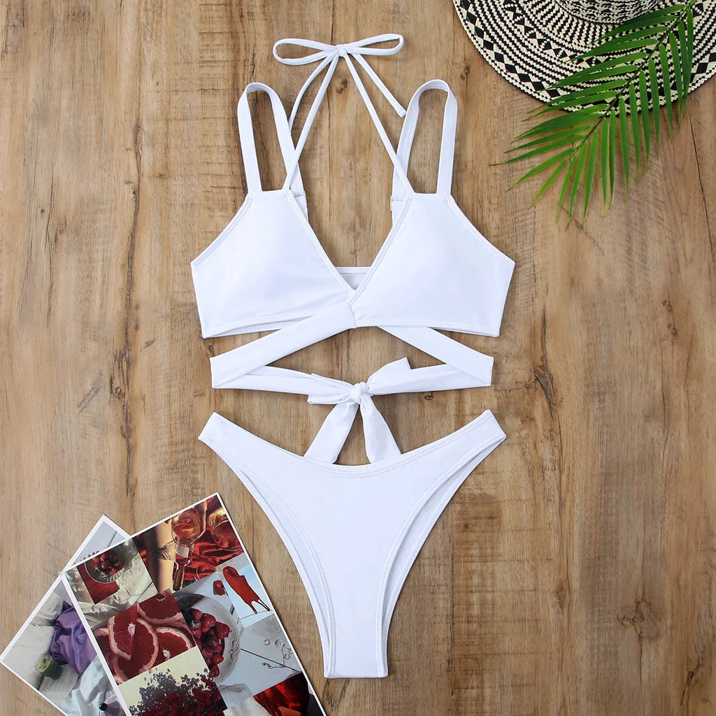 Women's solid colour strap bikini swimsuit in briefs style showing black, blue, red, rose red, and white colour options