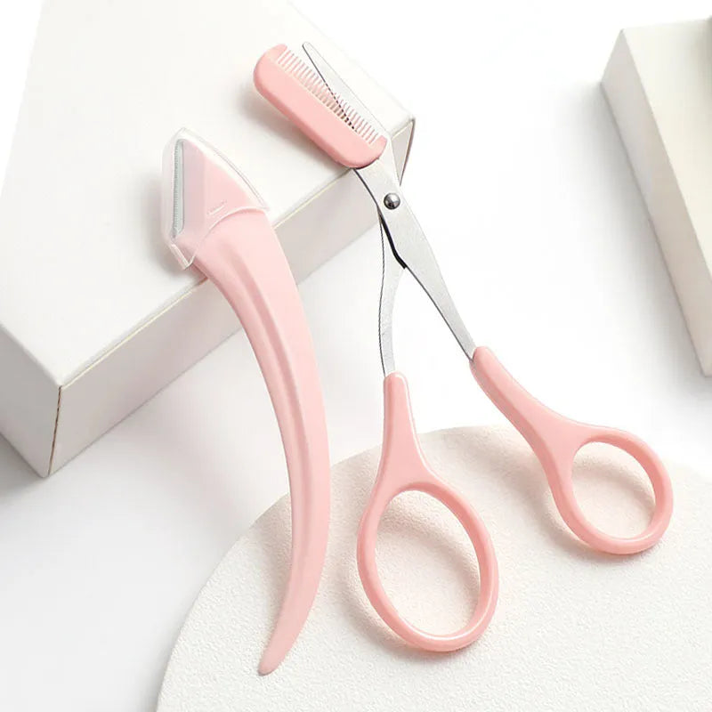 Close-up of a curved moon-shaped eyebrow trimming knife with a comb, in pink and white colours.