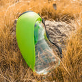 Blue portable dog water bottle with attached wide drinking bowl, showing key lock mechanism