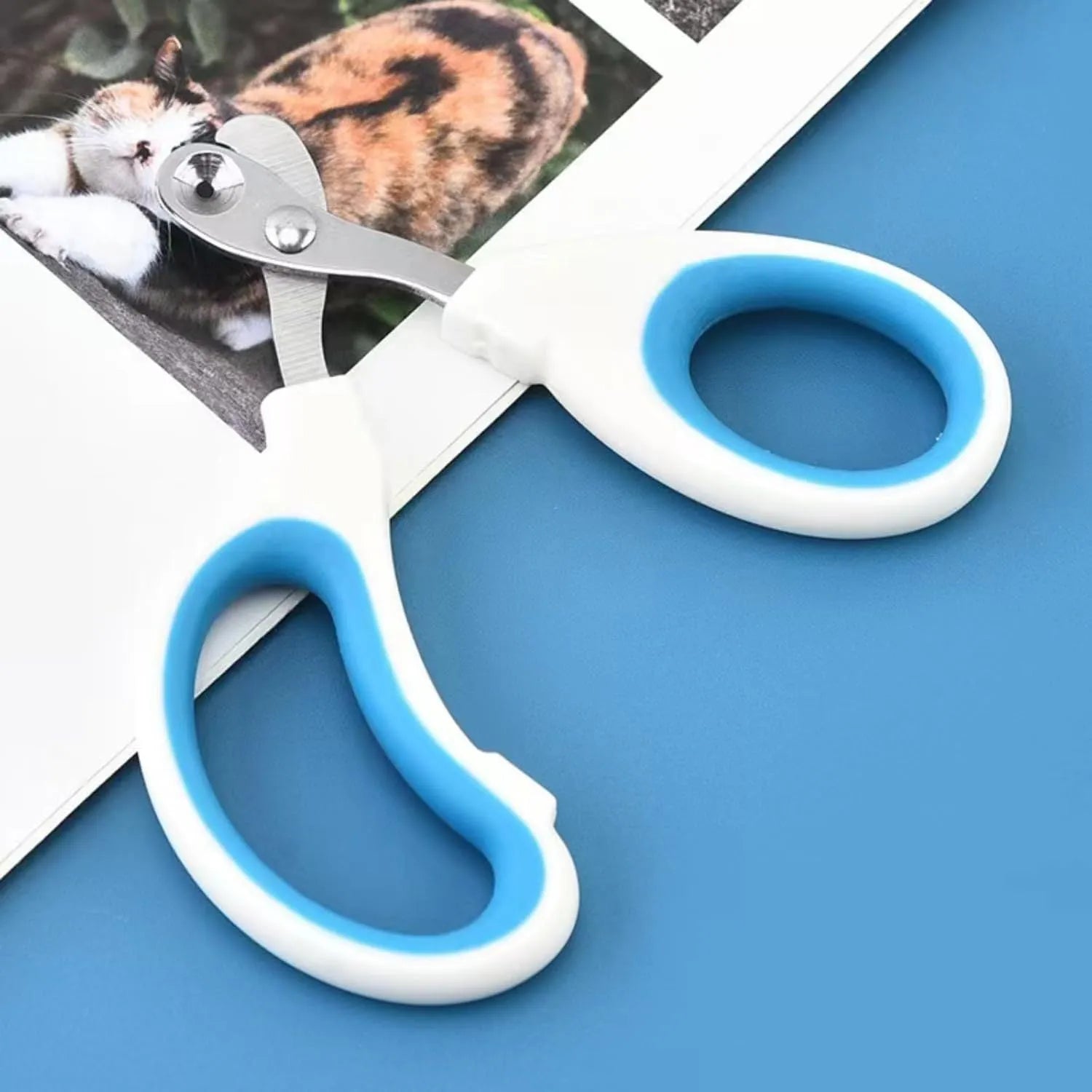 Blue cat nail clippers with circular safety hole and cushioned non-slip handle.