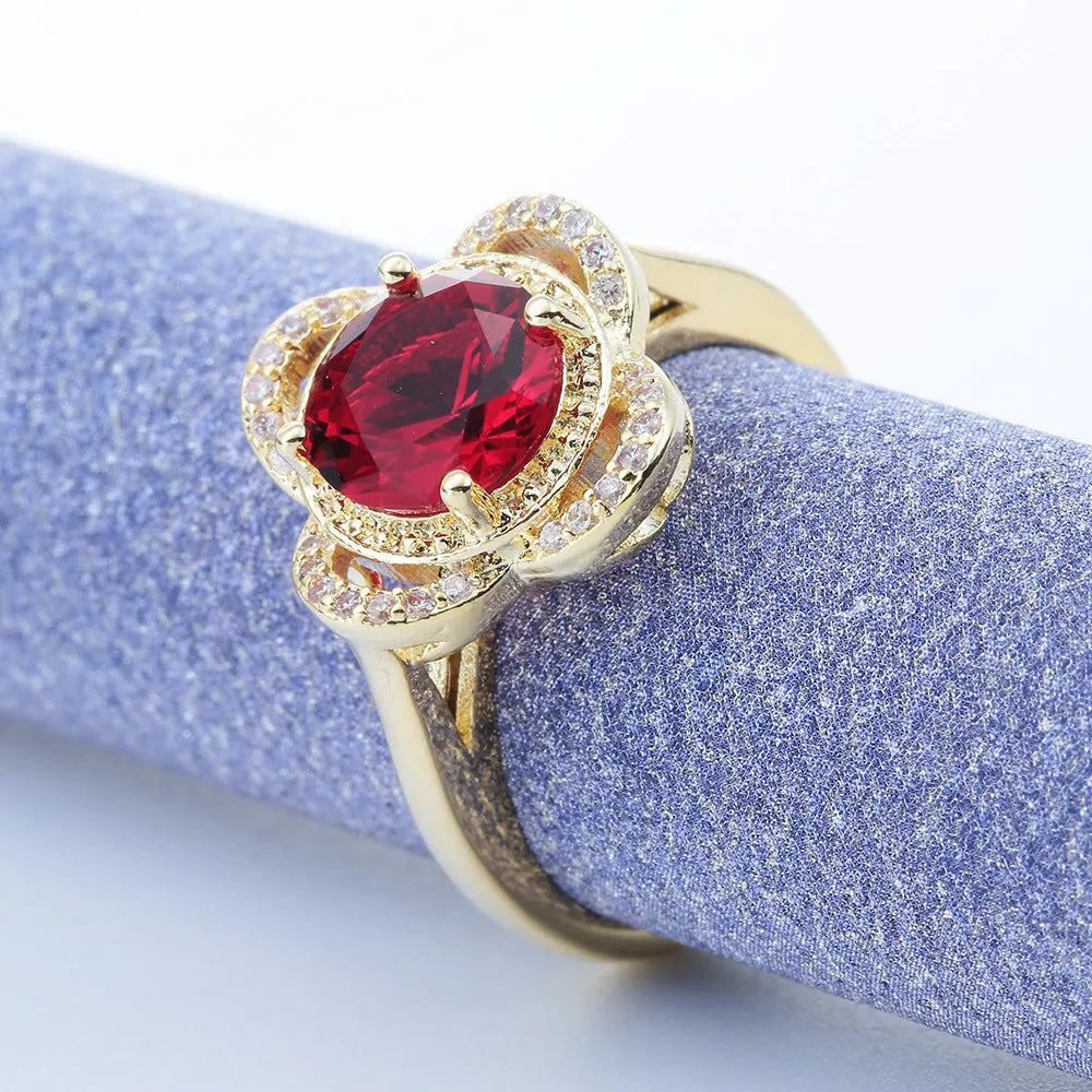 Copper ring with fruit shape and inlaid zircon details on a finger.