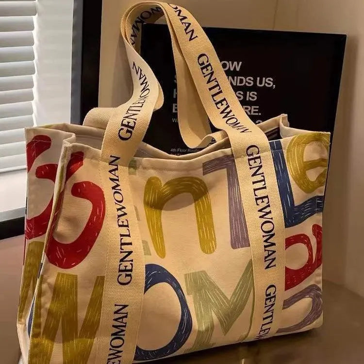 Large canvas women's tote bag with printed design, shown in available colour and pattern options