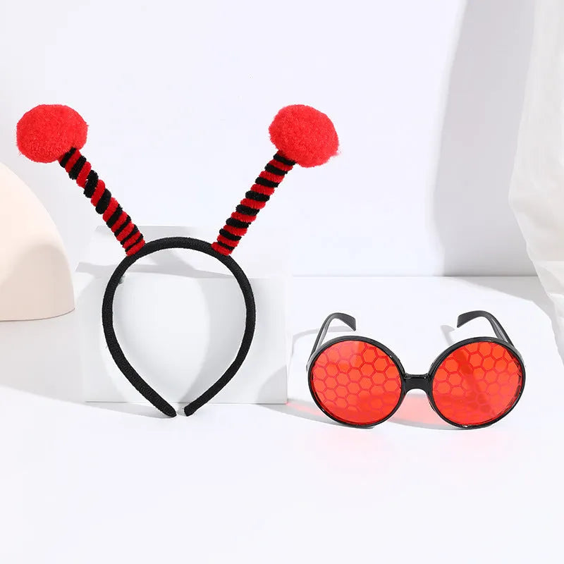 Yellow children's costume headband and glasses set with bee, butterfly, and ladybug patterns.