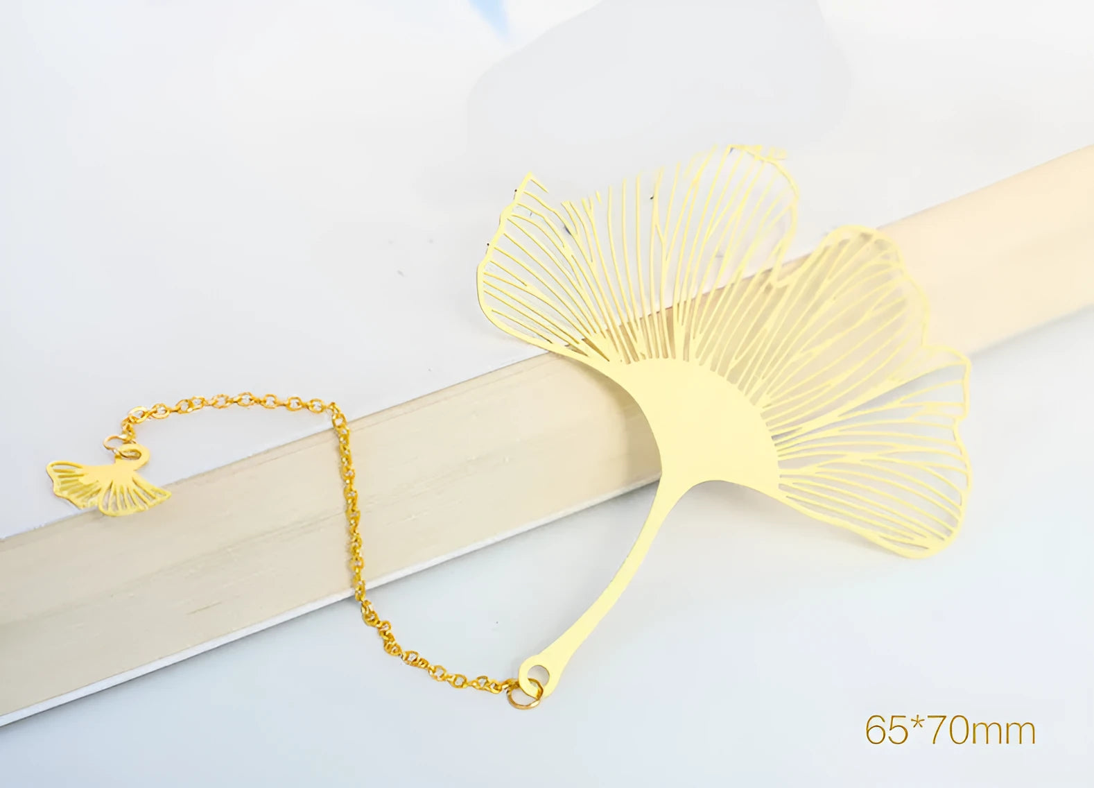 Brass metal bookmark with hollow leaf pattern design and rose gold tassel