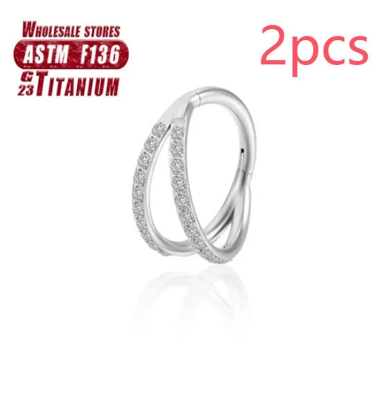 Titanium alloy nose ring on a plain background, shown in silver and gold finishes.