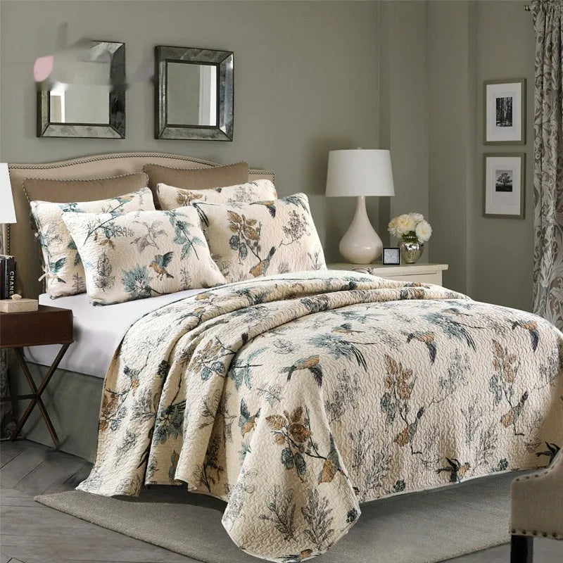 Quilted pure cotton bed cover set with printed pattern on a bed, includes two matching pillowcases.