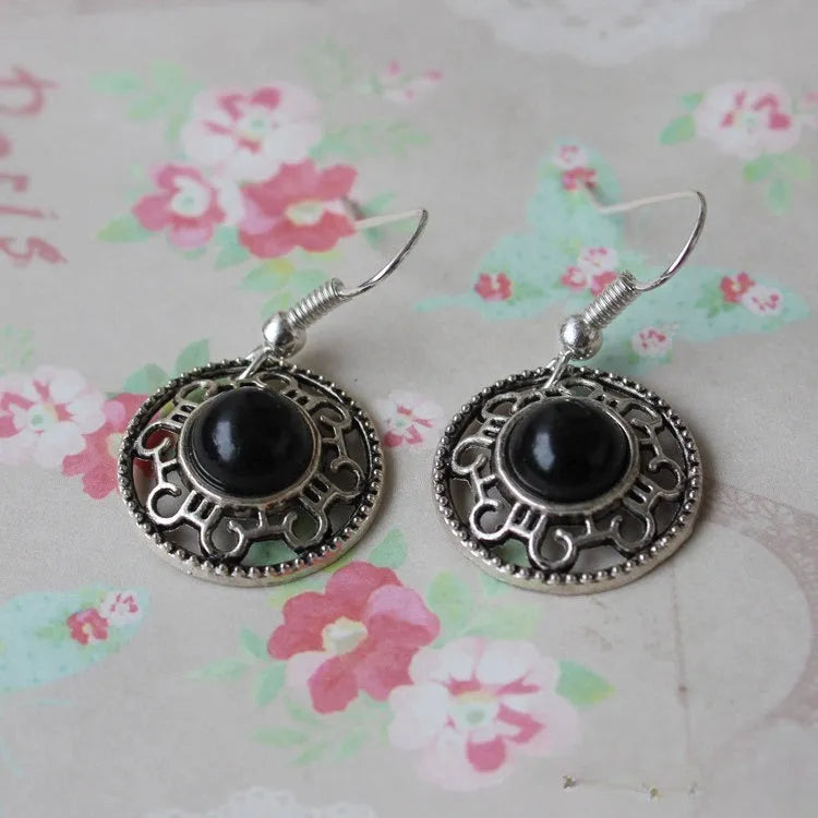 Miao silver earrings with turquoise geometric flower disk and totem patterns