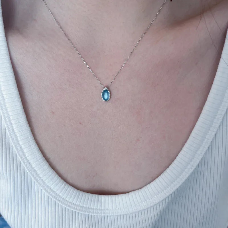 Women's navy blue water drop pendant necklace on adjustable copper cross chain