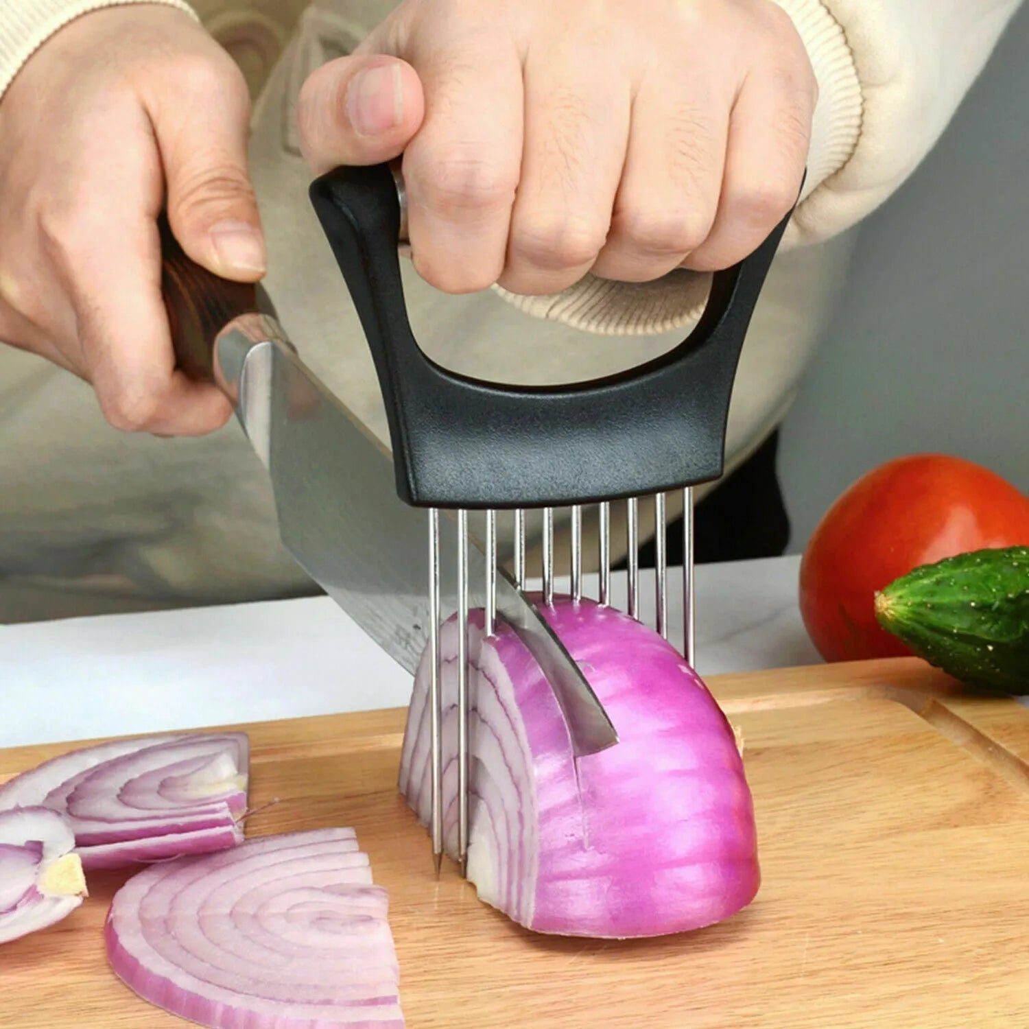 Stainless steel and ABS kitchen food slicer and onion holder on a work surface