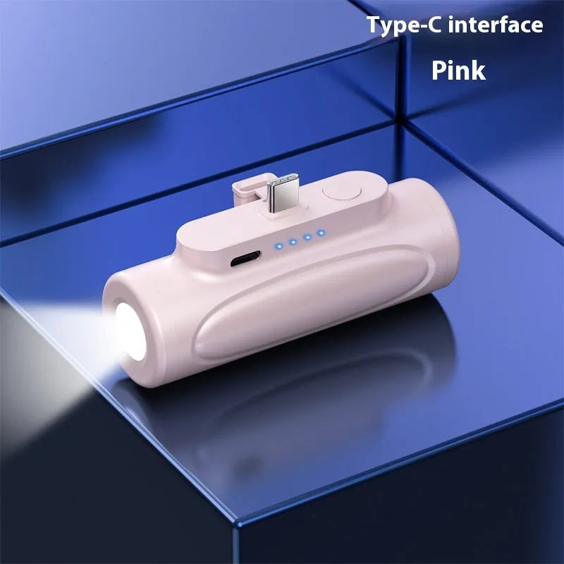 Black and pink creative power bank with integrated LED glare flashlight, showing Type-C and Apple port options.