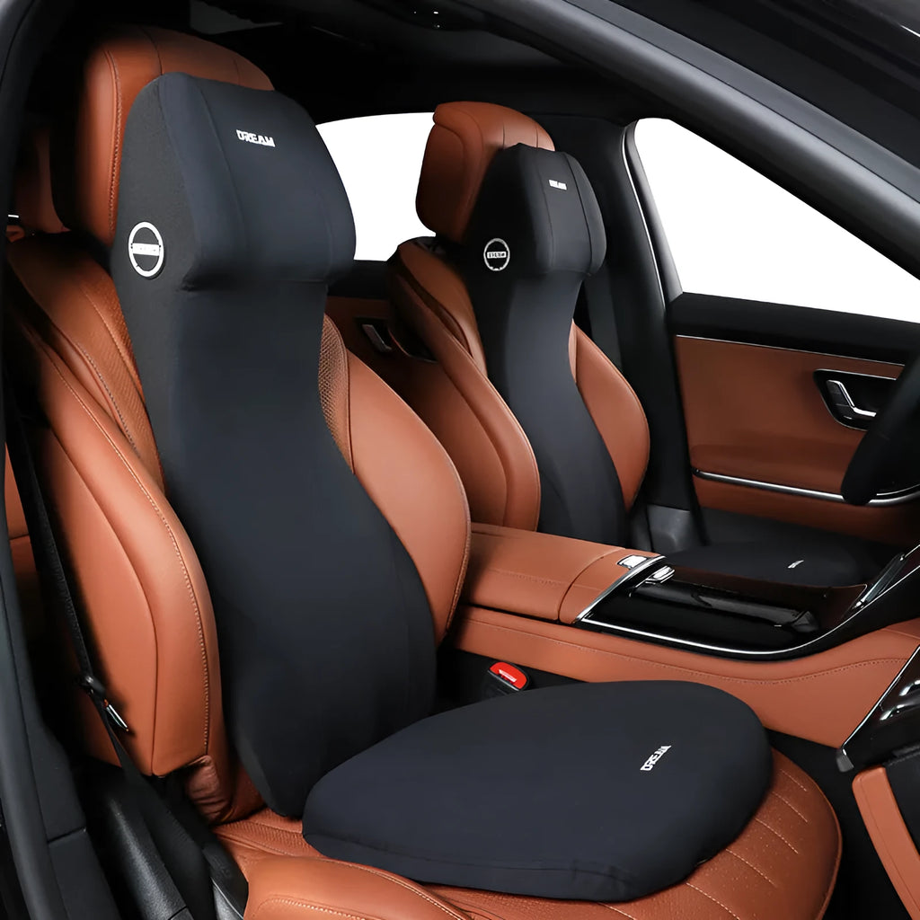 Black automotive memory foam cushion and lumbar support pillow on a car seat.