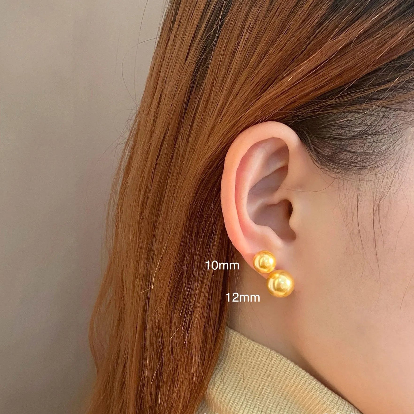 A pair of large silver pearl stud earrings with an eight-pointed star geometric design on a white background.