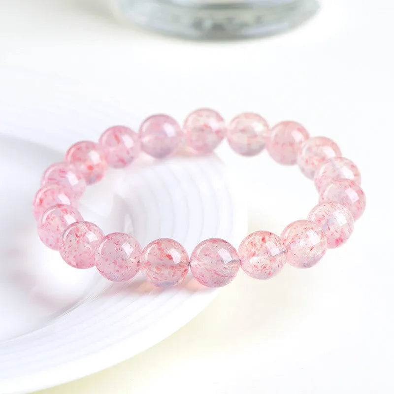 Strawberry quartz crystal bracelet with spherical 10-10.8mm beads in white water colour