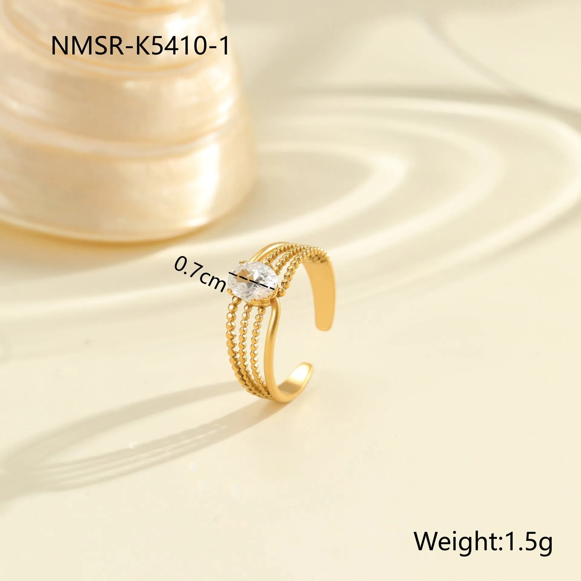 Gold-plated geometric stainless steel ring with inlaid zircon stones on a white background.
