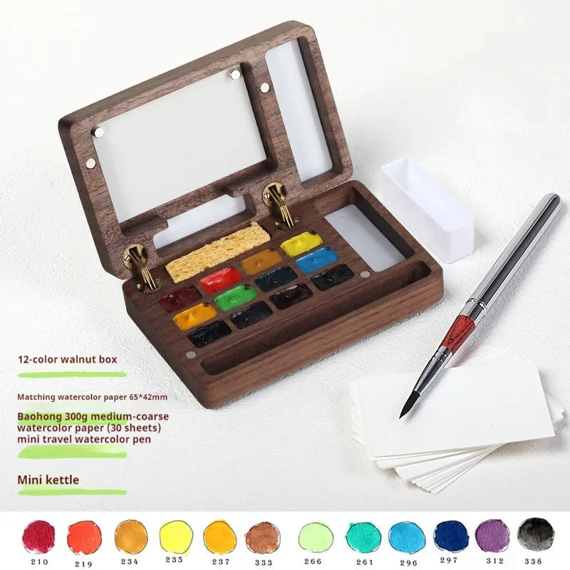 Mini walnut wood watercolour paint box open to show pigment pans with leather carrying bag