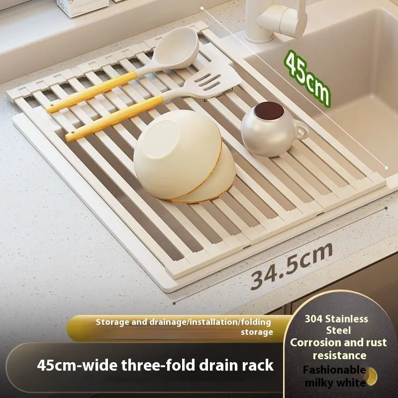 A milky white foldable stainless steel kitchen draining rack shown open on a countertop next to a sink.