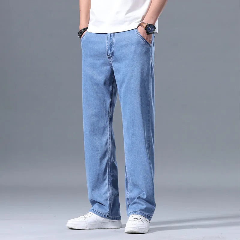Man wearing light blue loose straight-leg lyocell blend casual jeans.